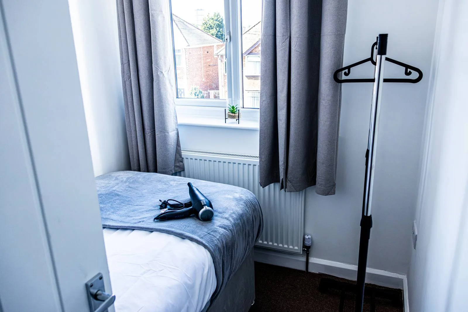 Sullivan Heights Coventry — bedroom with hanging storage