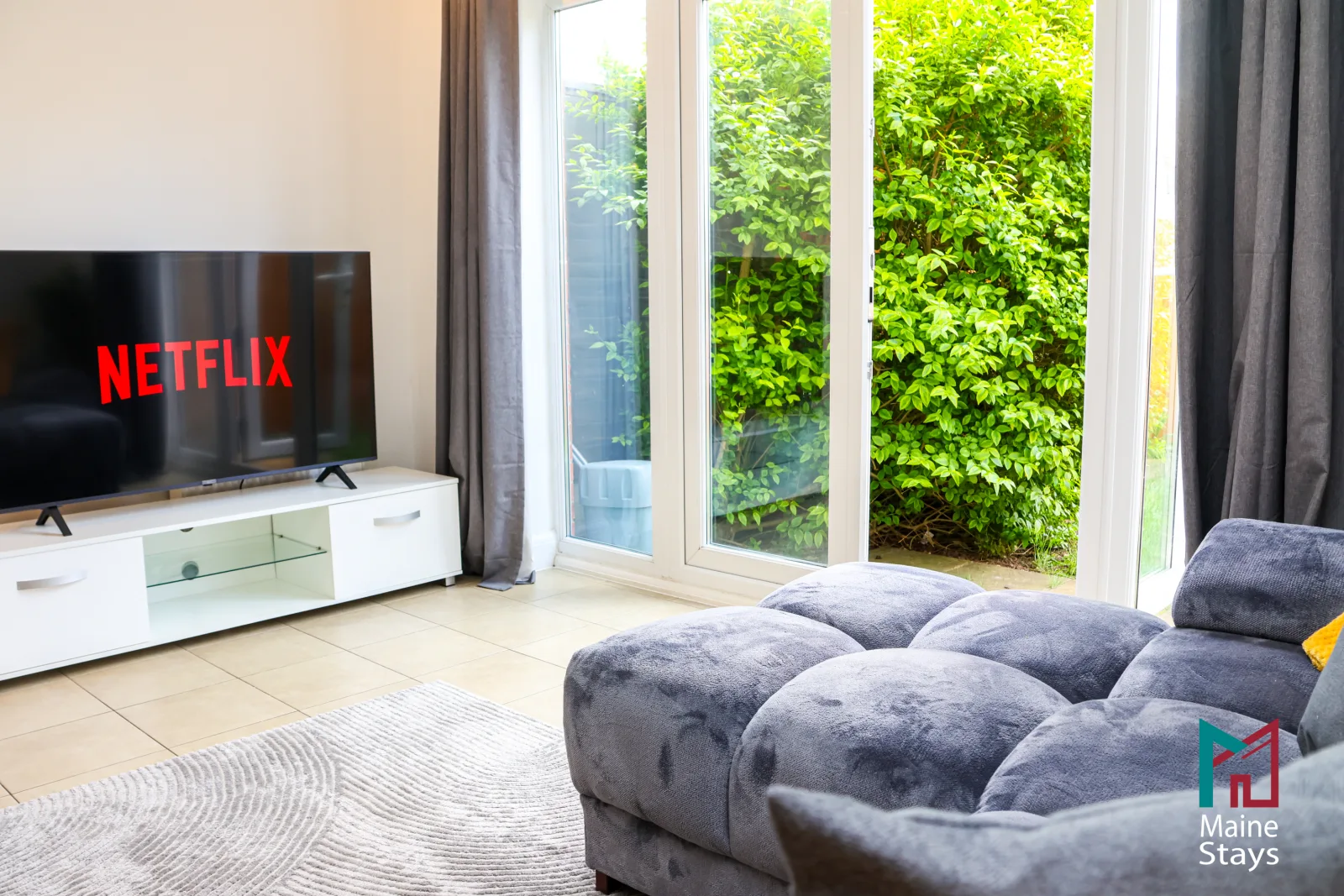 Humber Hub Coventry - Open-plan kitchen, dining and lounge: living room sofa tv